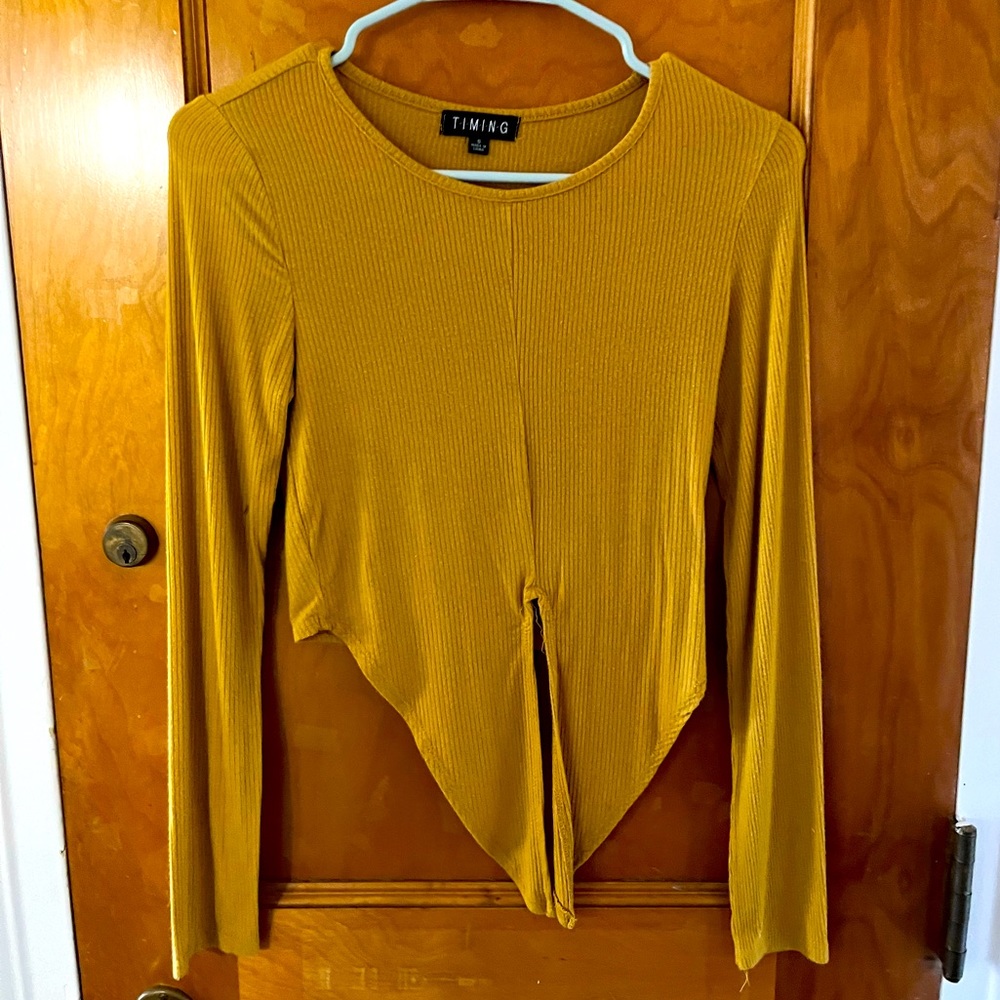 Yellow long sleeve top.